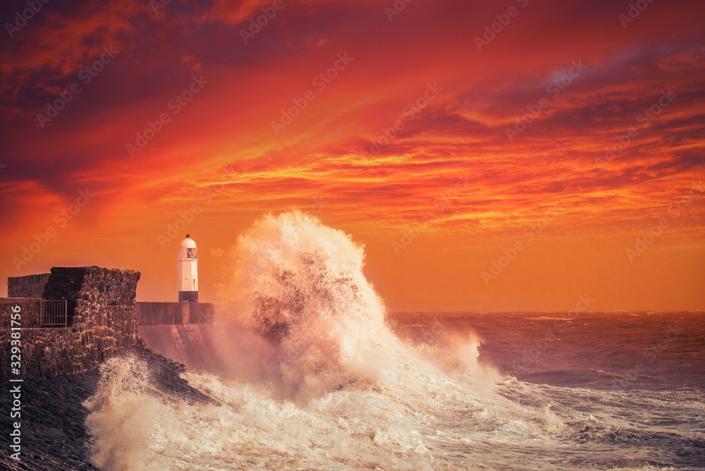 Porthcawl Lightouse and Waves at Sunset in South Wales, United Kingdom