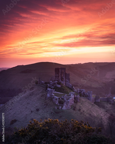 a bright sunset over corfe castle in dorset