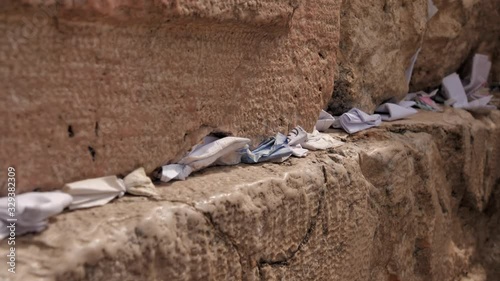 Footage of notes in the cracks of Western Wall (Kotel) Jerusalem. Israel. Dynamic video. Selective focus