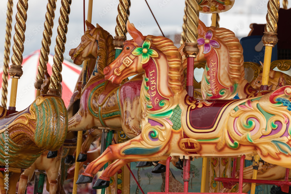 the painted horses on a traditional english carousel ride