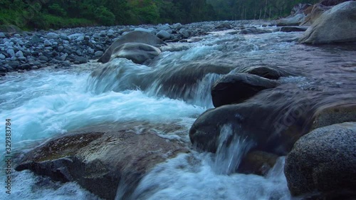 4K footage of Morning scenery river flow over the river on nature rural village. photo