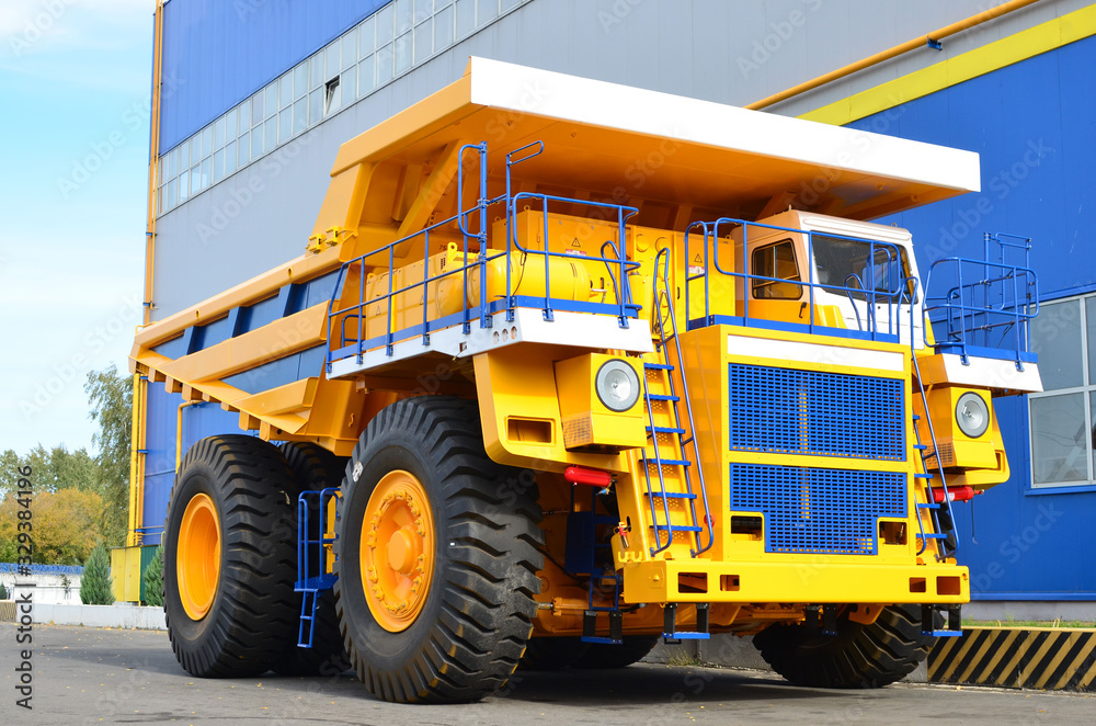 Giant mining dump truck, after being discharged from the conveyor, is tested at the factory test site. Heavy-duty truck manufacture by the heavy vehicle plant. Giant mining dump truck, after being discharged from the conveyor, is tested at the factory test site. Heavy-duty truck manufacture by the heavy vehicle plant.