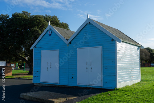 Two blue and white wooden beach huts
