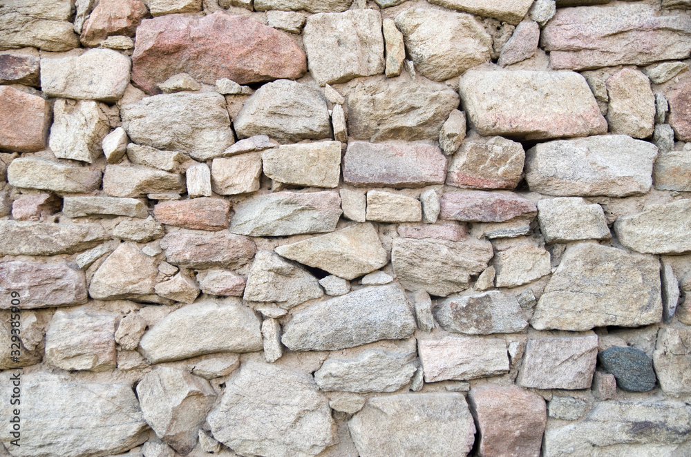 Fototapeta premium Old colorful stone wall closeup