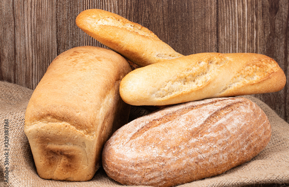 baked bread and baguette on wooden table background