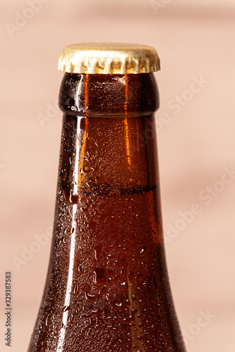 a bottle of amber beer with its capsule