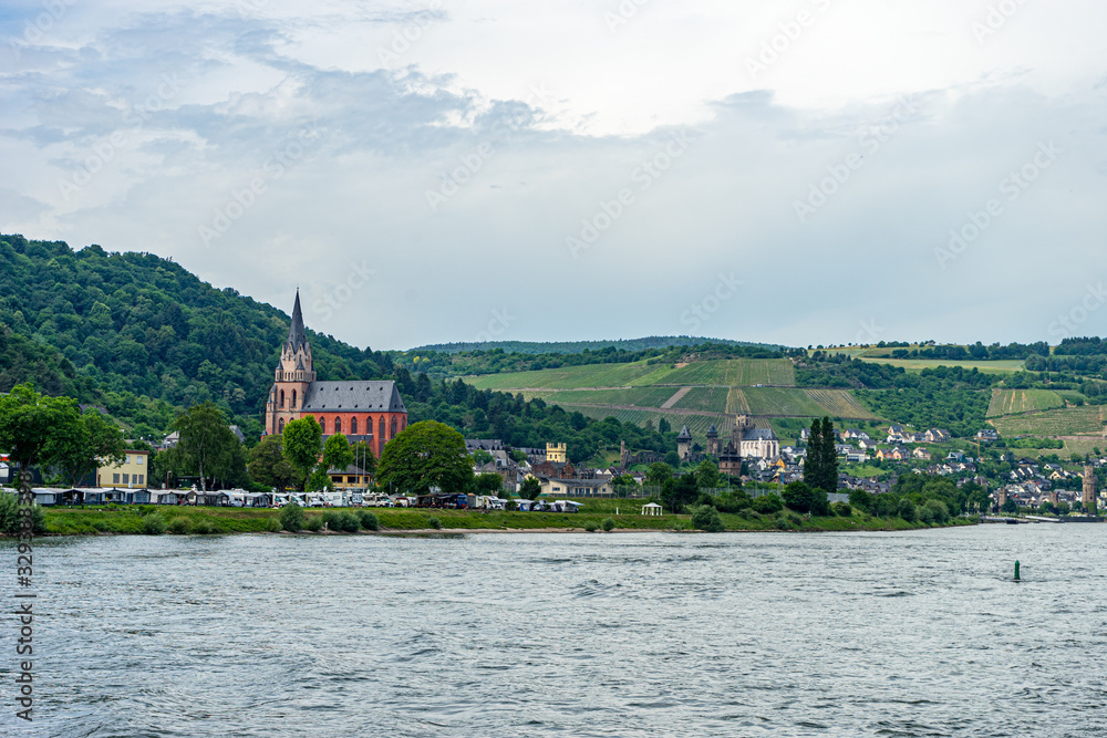 Obraz premium Germany, Rhine Romantic Cruise, a large body of water with a mountain in the background