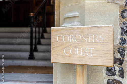 A wooden sign showing the words Coroners office