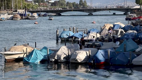 Wallpaper Mural Boats moored on Lake in a sunny day in Zurich Switzerland. Bridge with crossing cars on background. Torontodigital.ca