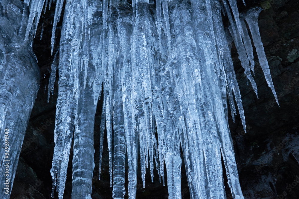 Crystal clear sharp icicles hanging down on the mountain Crystal clear sharp icicles hanging down on the mountain
