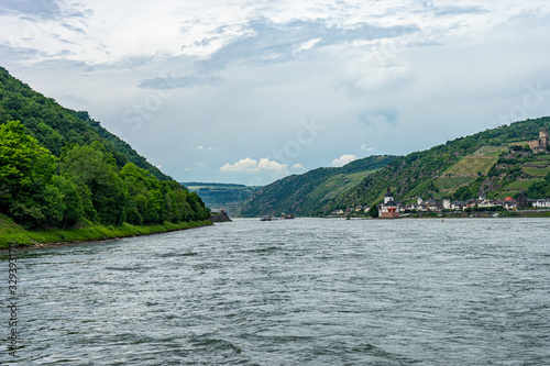 Germany, Rhine Romantic Cruise, a large body of water with a mountain in the background © SkandaRamana