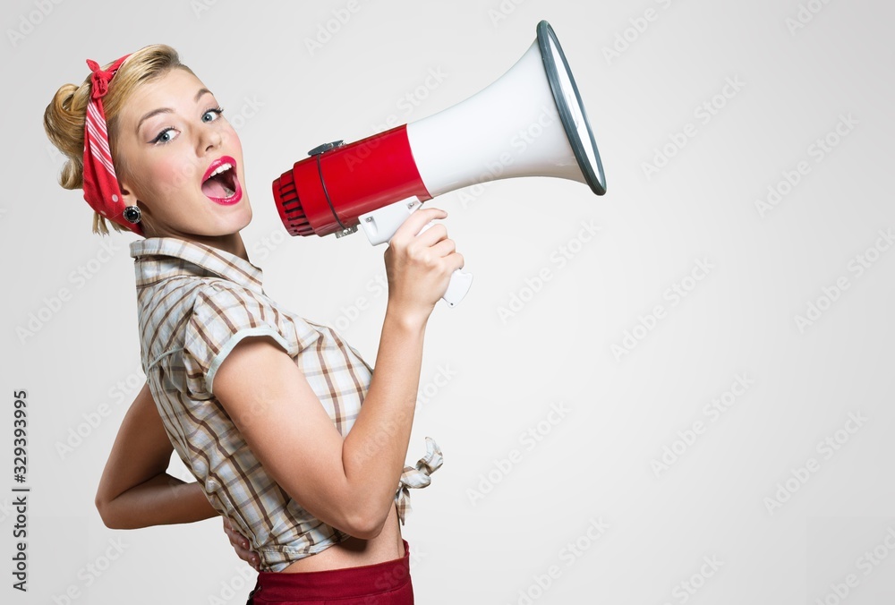 Fototapeta premium Beautiful woman holding megaphone and screams