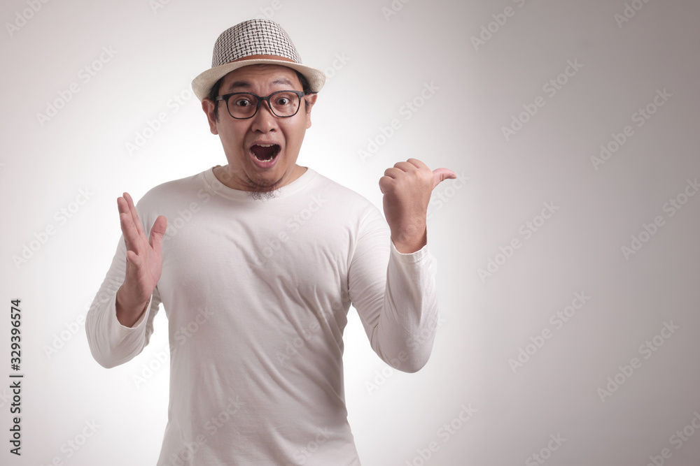 Young Man Showing and Pointing Something on His Side Young Man Showing and Pointing Something on His Side