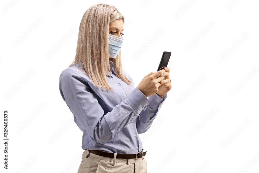 Woman wearing a medical mask and typing on a mobile phone Woman wearing a medical mask and typing on a mobile phone