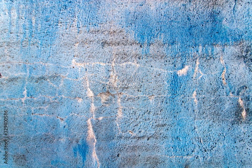 Cracked blue concrete wall. Abstract background.