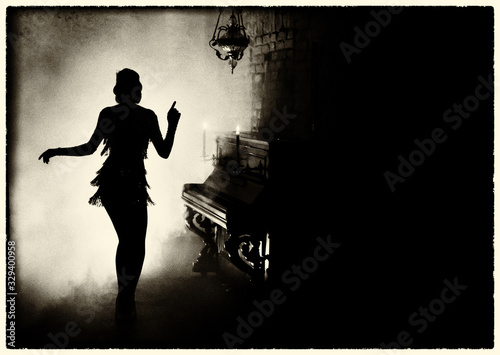 old fashioned photography. Dark mysterious silhouette retro woman style Great Gatsby. Girl dancing in short dress fashion old 1920s, backdrop room piano candle full smoke. Free space for invite text photo