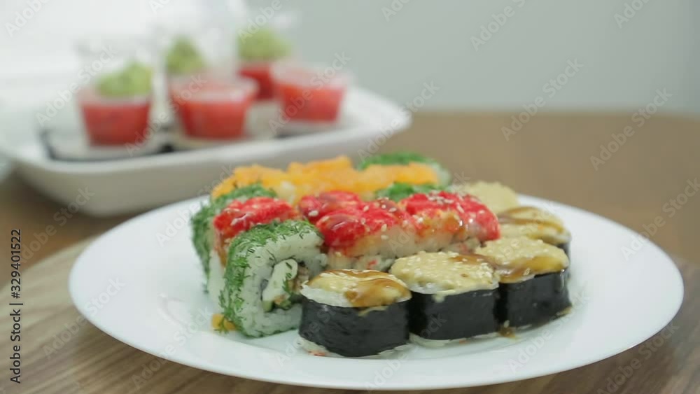Assorted rolls on a white plate rotates in a circle Assorted rolls on a white plate rotates in a circle
