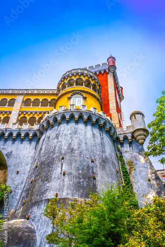 Palace of Pena in Sintra. Lisbon, Portugal. Famous landmark. Summer morning landscape with blue sky.