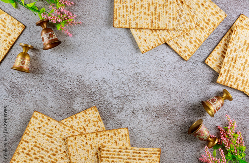 Four wine cups with matzah. Jewish holidays Passover concept.