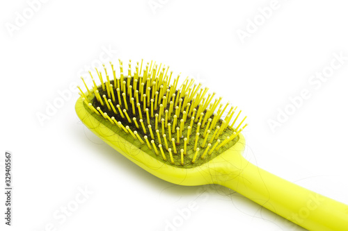 Hairs fall in comb  hair fall everyday serious problem.Hairs fall with a comb and problem hair on white background. Baldness trying hair brush. Close up . concept Hair loss  beauty  Beauty salon