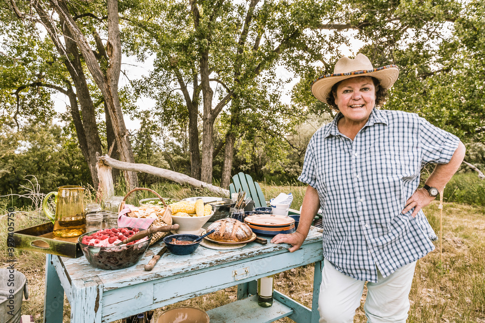 Ranchers wife stands in front of picnic table set with loads of great