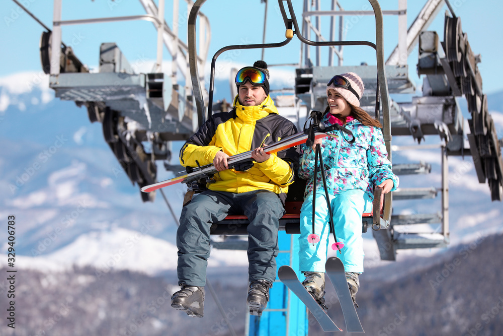 People using chairlift at mountain ski resort. Winter vacation People using chairlift at mountain ski resort. Winter vacation