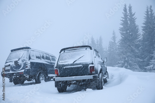 Cars covered with snow outdoors on winter day