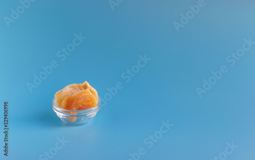 Dried fruits in assortment in glass cups on a blue background. The concept of a healthy lifestyle..
