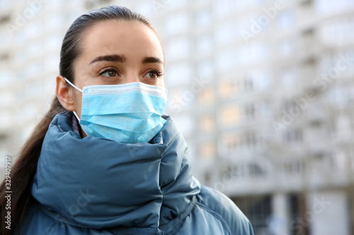 Tableau sur toile Woman wearing disposable mask outdoors. Dangerous virus