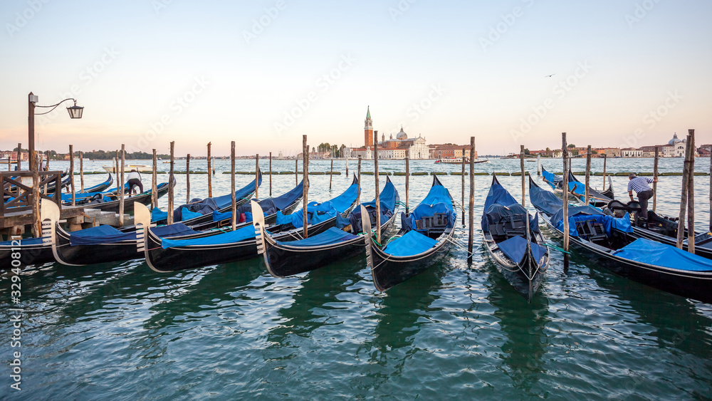 Gondolas moored by Saint Mark square with San Giorgio di Maggiore church, Venice