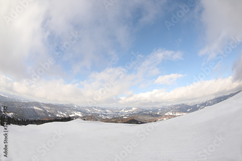 Picturesque mountain landscape with snowy hills under cloudy sky © New Africa