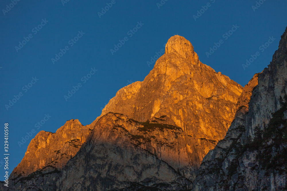 Awesome sunset over the dolomitic peaks overlooking the Braies lake, South Tyrol, Italy