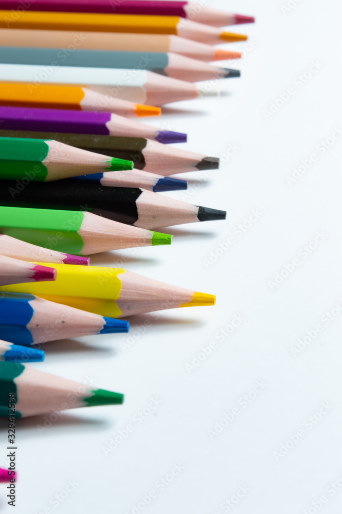 Close-Up Of Multi Colored Pencils Over White Background Close-Up Of Multi Colored Pencils Over White Background