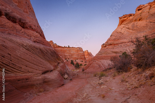 Rocks and Mountains along a trail to Tunnel Slot during sunny day with blue sky in Escalante National Monument, Grand Staircase trail, Utah, USA