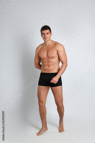 Man with sexy body on light background