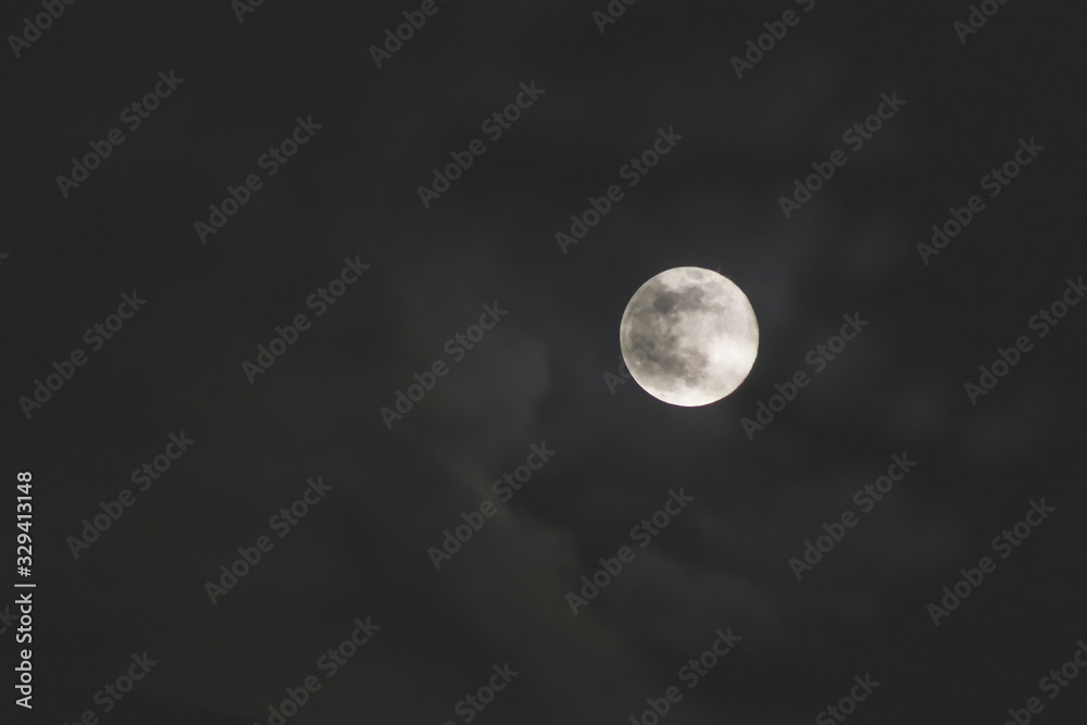 The full moon surrounded by clouds The full moon surrounded by clouds