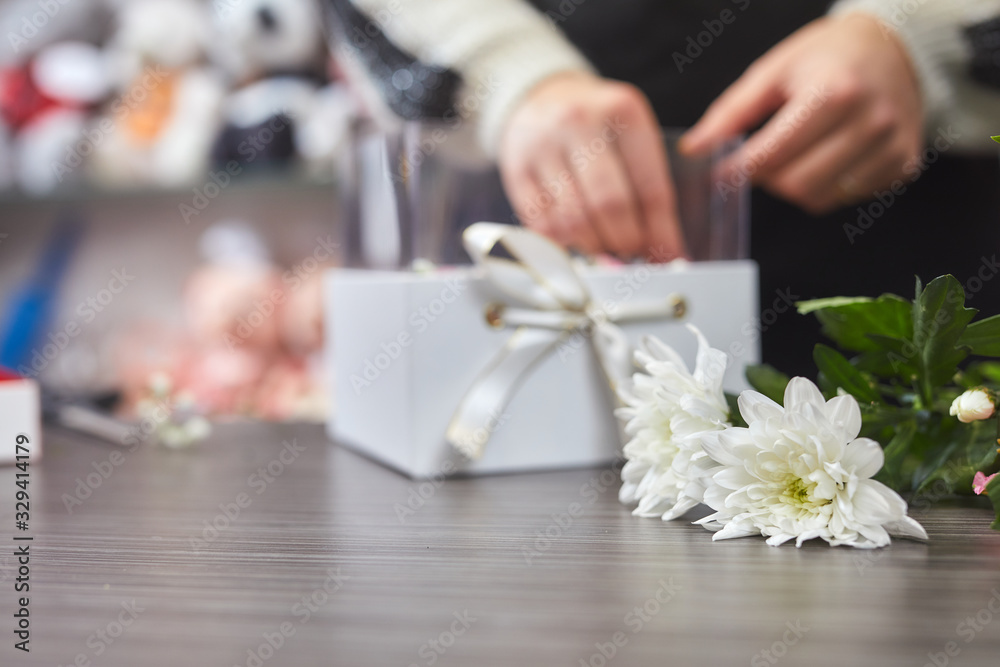 Cropped view of female florist making flower bouquet composition in flower shop. Valentines day concept. Cropped view of female florist making flower bouquet composition in flower shop. Valentines day concept.