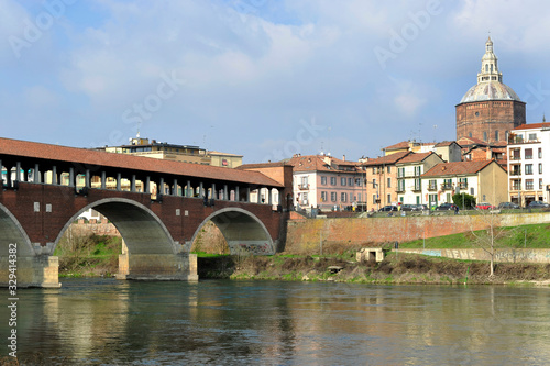 Pavia, Italy. february14,2018. The Ponte Coperto ("covered bridge") or the Ponte Vecchio ("Old Bridge") is a brick and stone arch bridge over the Ticino River in Pavia, Italy. Duomo di Pavia visible