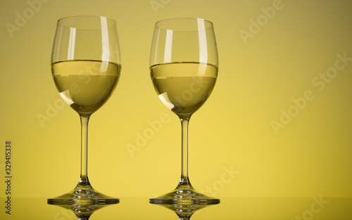 Two glasses of white wine on yellow background. Alcohol drink. Copy space.