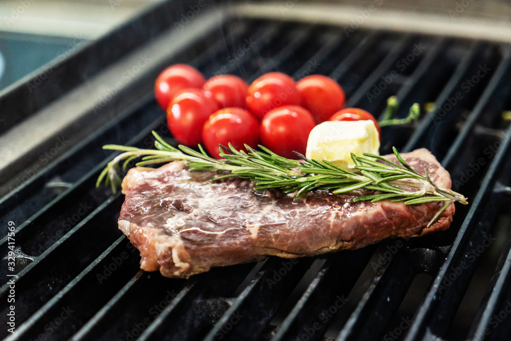 grilled steak with cherry tomatoes and rosemary