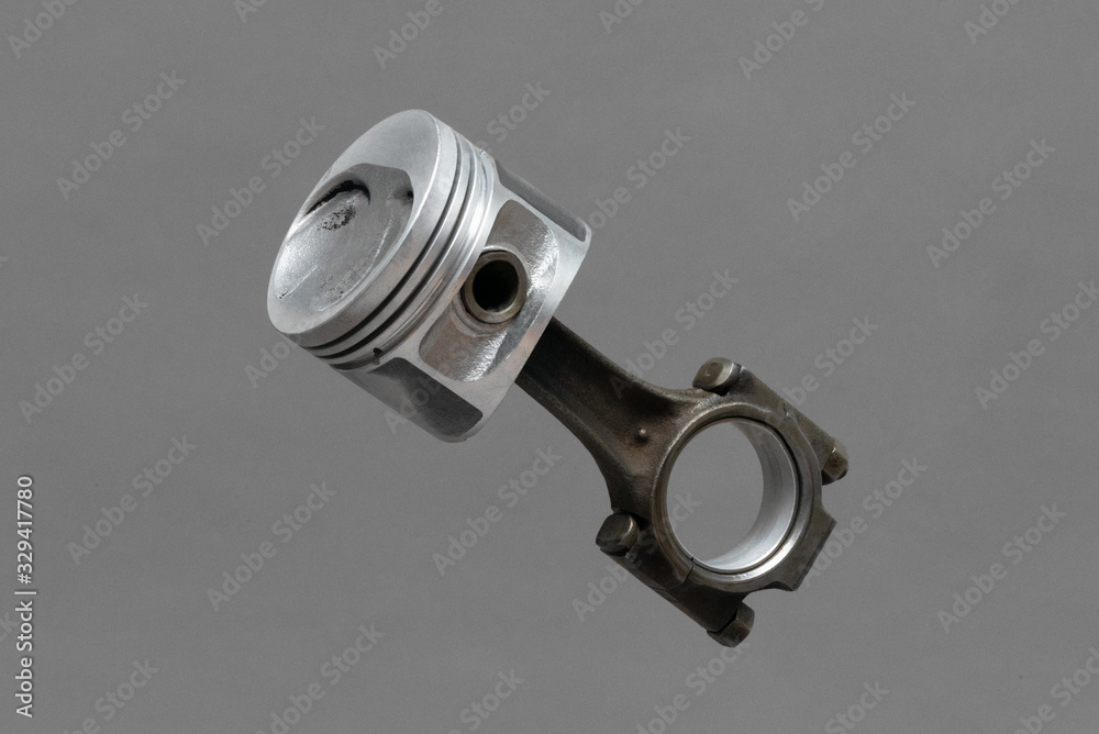 Car engine piston isolated on gray background. Car engine piston isolated on gray background.
