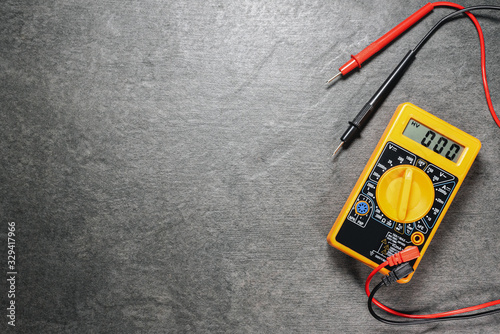 Multimeter on gray flat lay background with copy space. photo