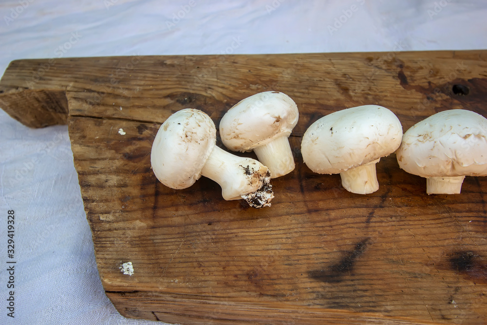 fresh champignons on a wooden board