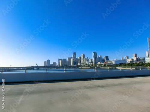 Miami skyscrapers with bridge over sea in the day.