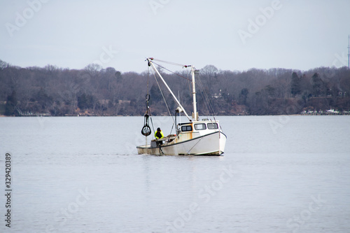 Photos a commercial oyster boat dredging for oysters in the chesapeake bay