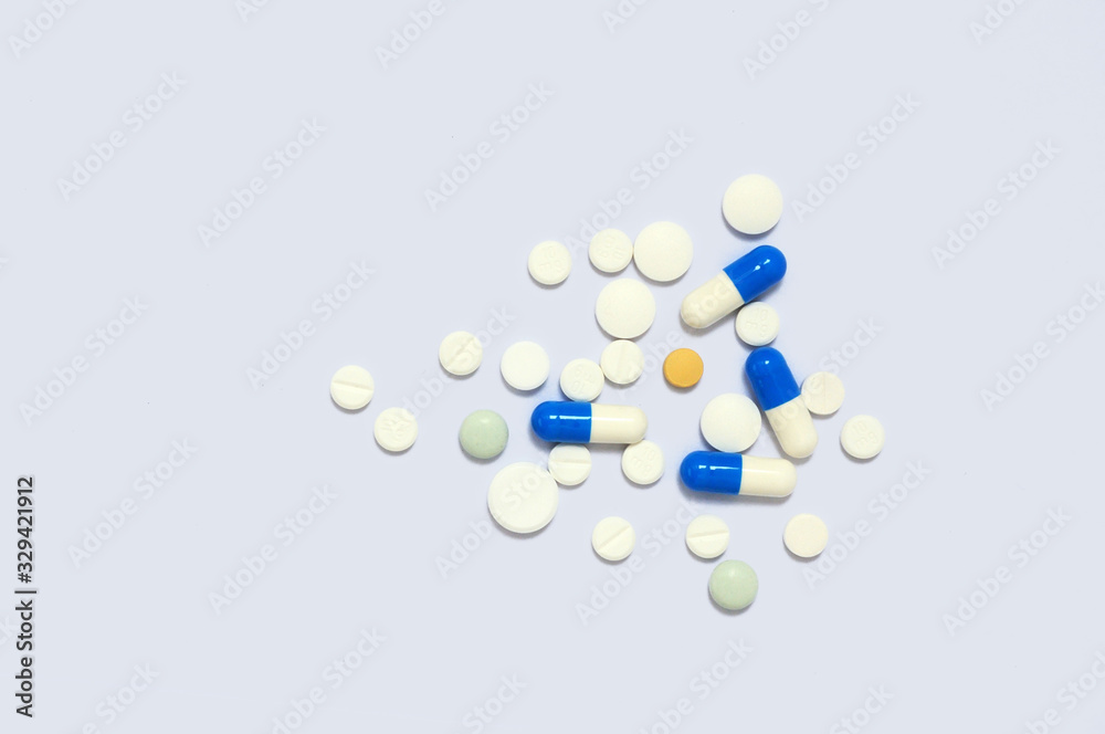 Colorful medicine tablets is on white background.