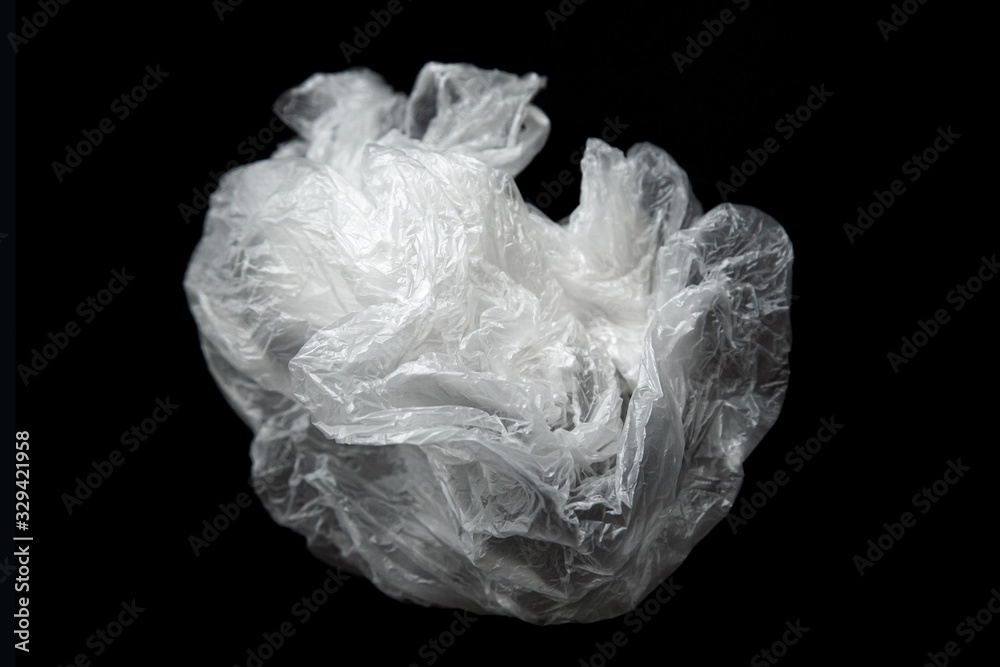 Empty wrinkled plastic bag isolated on a black background. Used plastic