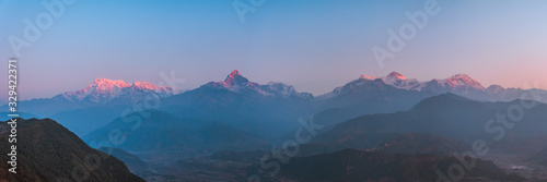 Sunrise panoramic view from Sarangkot Hill with Himalayan Mountains in background such as Annapurna, Hiunchuli, Kangshar Kang (Roc Noir), Mardi Himal, Machapuchare and Lamjung Himal, Pokhara, Nepal photo