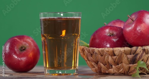 Fresh Apple juice in the glass rotates. photo