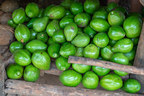 Green avocado stack at grocery on tropical marketplace outdoor,Samana peninsula,Dominican republic. © robertobinetti70